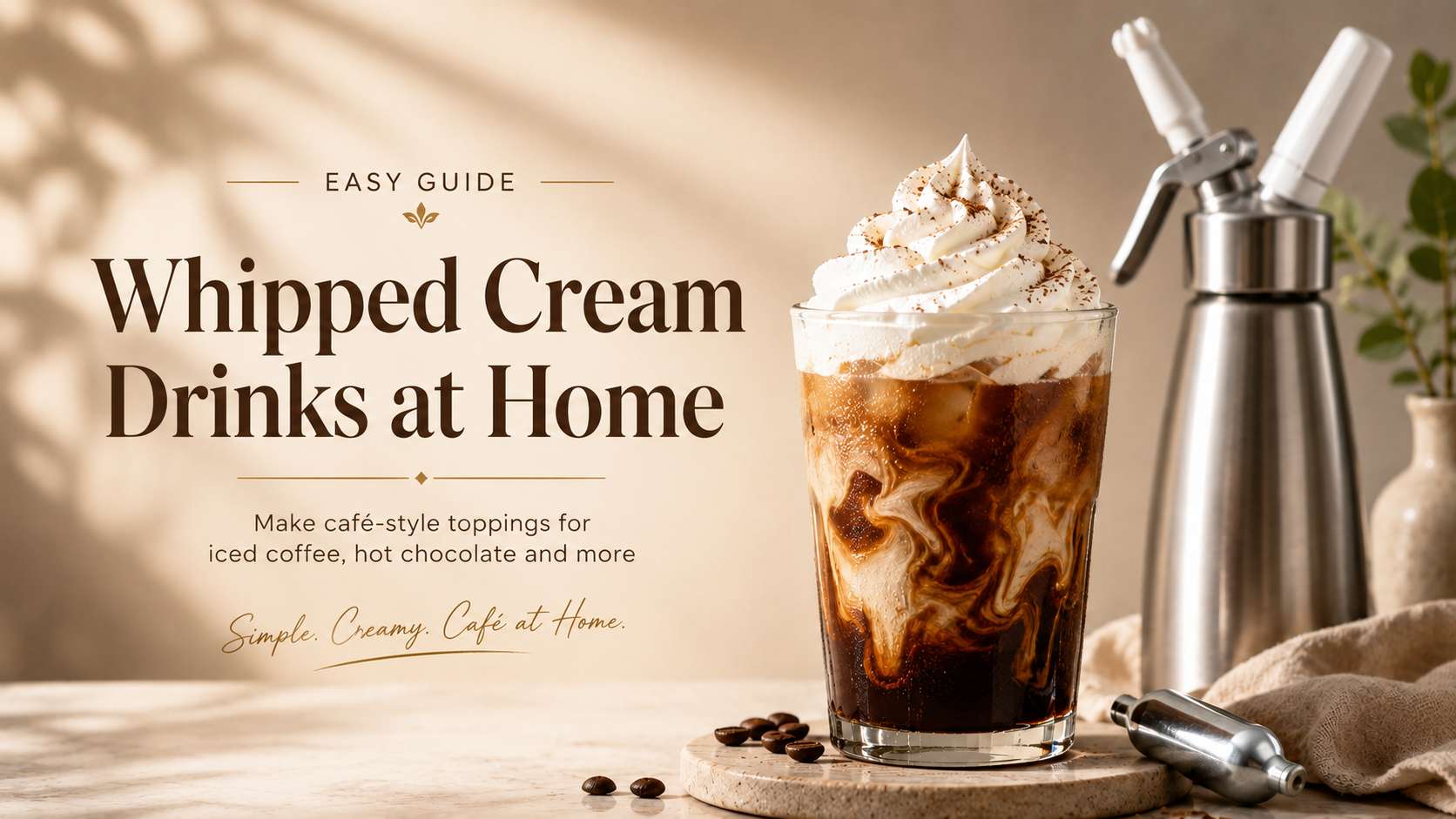 Alt text: Iced coffee topped with whipped cream beside a cream dispenser and charger for homemade whipped cream drinks.